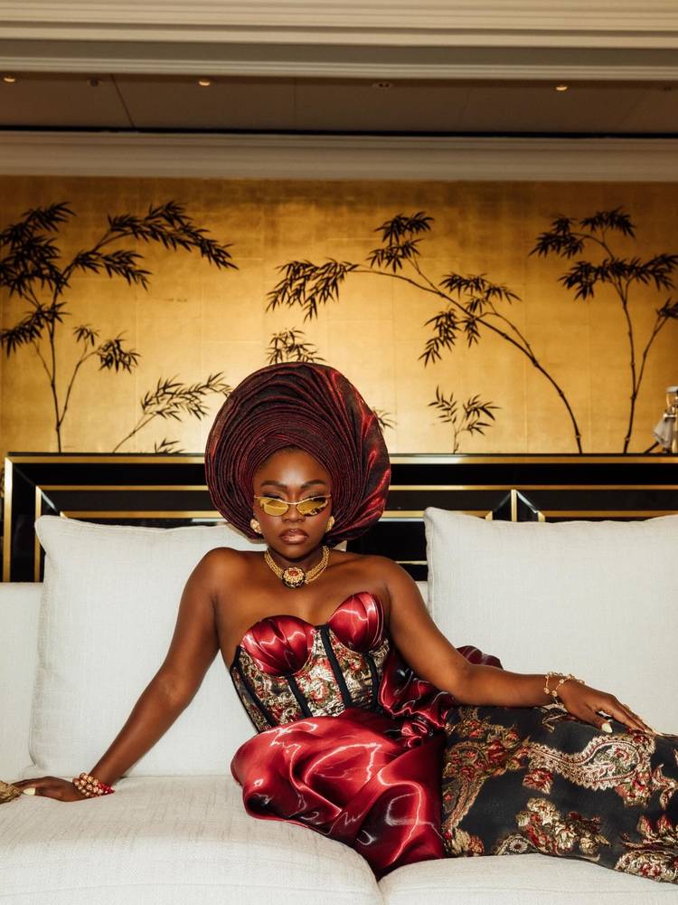 Fisayo Alonge in a burgundy satin gele and beaded gown