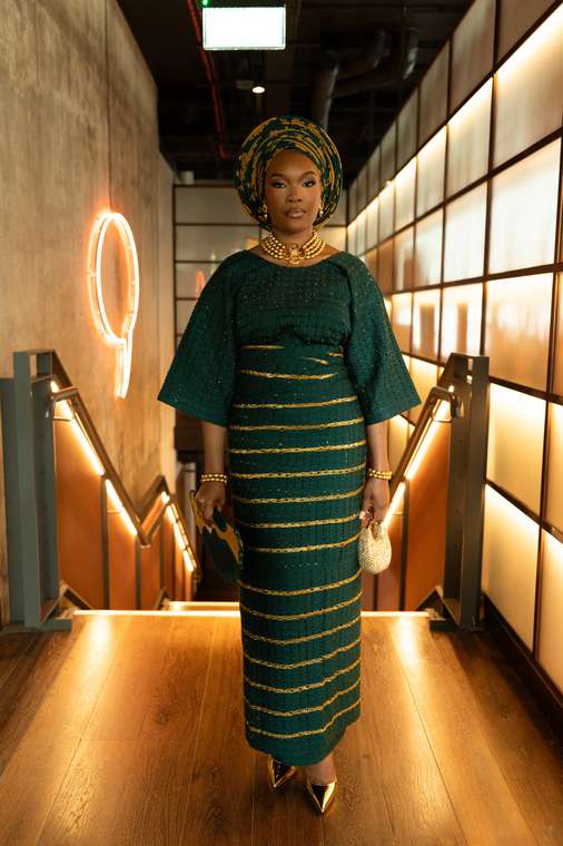 Gele Glamzzz client in an emerald green and gold aso-oke gele and matching wrapper, London