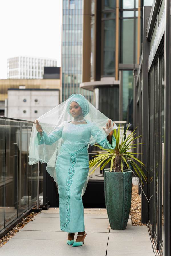 Client in a mint green traditional look with matching gele and veil