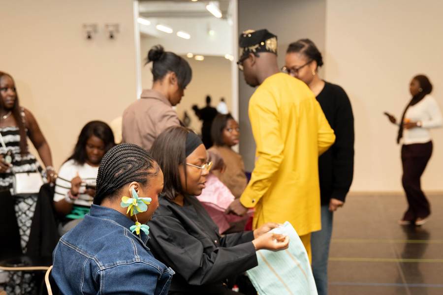 Founder of Gele Glamzzz backstage with the styling team