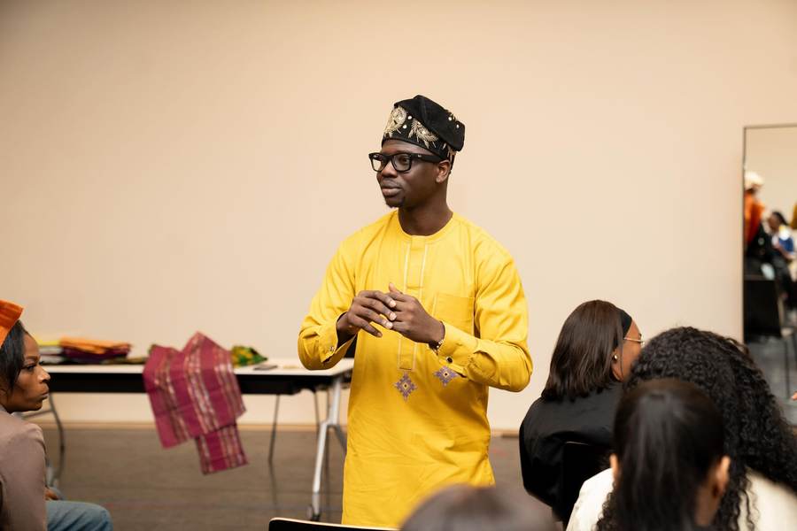 Founder of Gele Glamzzz speaking to a room during a gele styling workshop
