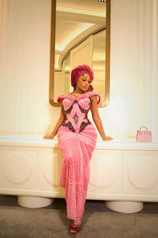 Client in a beaded pink gown and matching gele